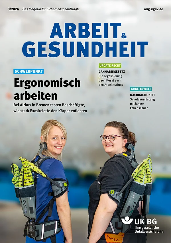 Titelbild Magazin arbeit & gesundheit: Zwei Frauen, die ein Exoskelett tragen und in die Kamera lächeln. Mit Headline: "Ergonomisch arbeiten"