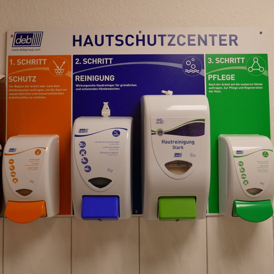 Vier Pumpspender mit Hautreinigungs- und Hautpflegemitteln